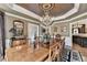 Refined dining room showcasing a chandelier, custom wall trim, and elegant furniture suited for formal dining at 803 Amerden Ponds Ct, Johns Creek, GA 30097