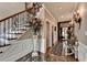 Elegant hallway featuring marble floors, decorative staircase, and detailed wall trim for an upscale ambiance at 803 Amerden Ponds Ct, Johns Creek, GA 30097