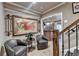 Elegant hallway featuring seating, artwork, decorative sconces, and staircase leading to the home's upper levels at 803 Amerden Ponds Ct, Johns Creek, GA 30097