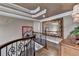 Lovely hallway with hardwood floors, decorative mirror, ornate ceiling, and custom staircase at 803 Amerden Ponds Ct, Johns Creek, GA 30097