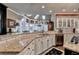 Gourmet kitchen with granite countertops, custom cabinets, a central island with a cooktop, and a breakfast area at 803 Amerden Ponds Ct, Johns Creek, GA 30097