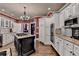 Gourmet kitchen featuring a central island with cooktop, granite countertops, stainless steel appliances, and lots of cabinets at 803 Amerden Ponds Ct, Johns Creek, GA 30097