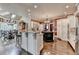 Spacious kitchen featuring granite countertops, a large island, stainless steel appliances, and hardwood flooring at 803 Amerden Ponds Ct, Johns Creek, GA 30097
