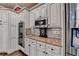 Kitchen detail showcasing granite countertops, stainless steel appliances, and custom cabinetry with a built-in double oven at 803 Amerden Ponds Ct, Johns Creek, GA 30097