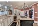 Gourmet kitchen featuring granite countertops, a black island, stainless steel appliances, and beautiful cabinetry at 803 Amerden Ponds Ct, Johns Creek, GA 30097