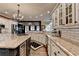 Spacious kitchen featuring granite countertops, custom cabinets, stainless steel appliances, and a central island with a cooktop at 803 Amerden Ponds Ct, Johns Creek, GA 30097