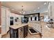 Gourmet kitchen with custom cabinetry, granite countertops, stainless steel appliances, wine cooler, and an island cooktop at 803 Amerden Ponds Ct, Johns Creek, GA 30097