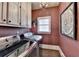 Bright laundry room features updated washer and dryer, storage cabinets, light fixture, and lovely accent wall at 803 Amerden Ponds Ct, Johns Creek, GA 30097