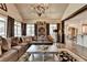Open living room with a large sectional sofa, hardwood floors, and views into dining and kitchen areas at 803 Amerden Ponds Ct, Johns Creek, GA 30097