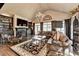 Spacious living room with a vaulted ceiling, fireplace, built-in shelving, and large windows for natural light at 803 Amerden Ponds Ct, Johns Creek, GA 30097