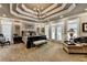 Spacious main bedroom featuring a tray ceiling, a decorative chandelier, and French doors at 803 Amerden Ponds Ct, Johns Creek, GA 30097
