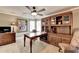 Home office featuring a large desk, wood built-ins, carpeted floors, and a ceiling fan at 803 Amerden Ponds Ct, Johns Creek, GA 30097