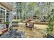 Inviting stone patio with outdoor seating, perfect for entertaining, overlooking the picturesque backyard at 803 Amerden Ponds Ct, Johns Creek, GA 30097