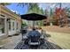 Outdoor patio with table, chairs and an umbrella, perfect for outdoor dining at 803 Amerden Ponds Ct, Johns Creek, GA 30097