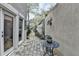 Private patio area featuring stone pavers, garden gate, and sitting area at 803 Amerden Ponds Ct, Johns Creek, GA 30097