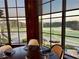 Scenic view from the restaurant overlooking the golf course with a table set for dining at 803 Amerden Ponds Ct, Johns Creek, GA 30097