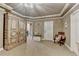 Neutral sitting room with storage, chair, clock, and doors offering flexible living spaces at 803 Amerden Ponds Ct, Johns Creek, GA 30097