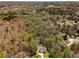 An aerial perspective of a home surrounded by a lush, wooded area and neighboring properties at 263 Keller Dr, Mcdonough, GA 30252
