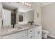 Bathroom featuring double vanity with granite counters, white cabinets, and large mirror at 263 Keller Dr, Mcdonough, GA 30252