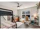 Bedroom featuring a bunk bed, ceiling fan, desk, and a window that provides natural light at 263 Keller Dr, Mcdonough, GA 30252