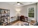 Bedroom featuring a dark wood desk, shelving unit, and a natural light-filled window at 263 Keller Dr, Mcdonough, GA 30252