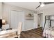Bedroom with a large closet, modern ceiling fan, and plank flooring at 263 Keller Dr, Mcdonough, GA 30252