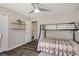 Well-lit bedroom showcasing a bunk bed, floating shelves, and a ceiling fan at 263 Keller Dr, Mcdonough, GA 30252
