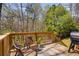 Inviting wooden deck with seating, plants, and a grill, great for outdoor enjoyment at 263 Keller Dr, Mcdonough, GA 30252