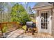 Wooden deck with grill and outdoor seating, perfect for relaxing and grilling outdoors at 263 Keller Dr, Mcdonough, GA 30252