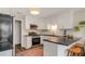 Modern kitchen with white cabinets, granite countertops, stainless steel appliances, and a breakfast bar with seating at 263 Keller Dr, Mcdonough, GA 30252