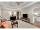 Bright and airy living room with hardwood floors, tray ceilings, and a view into the modern kitchen, enhancing open-concept living at 263 Keller Dr, Mcdonough, GA 30252