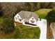 Aerial view highlights the white home, green grass and fresh driveway at 4440 Cannon Rd, Loganville, GA 30052
