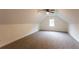 Finished attic space featuring neutral carpet and natural light at 4440 Cannon Rd, Loganville, GA 30052