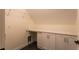 Attic laundry room with white cabinets and countertop at 4440 Cannon Rd, Loganville, GA 30052