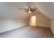 Finished attic space featuring neutral carpet, a ceiling fan, and a doorway at 4440 Cannon Rd, Loganville, GA 30052