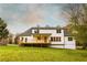 Back exterior featuring a covered deck and large windows overlooking a spacious lawn at 4440 Cannon Rd, Loganville, GA 30052