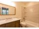 Bright bathroom features a marble countertop, tub with shower and glass shelving for a fresh, modern aesthetic at 4440 Cannon Rd, Loganville, GA 30052