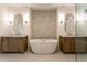 A luxury bathroom displays a freestanding tub between two vanities and a glass shower enclosure at 4440 Cannon Rd, Loganville, GA 30052