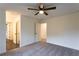 Bright, carpeted bedroom with ceiling fan and entry to rooms with dark tile flooring at 4440 Cannon Rd, Loganville, GA 30052