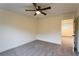 Bedroom boasts neutral carpet, a ceiling fan, and doorway to bathroom at 4440 Cannon Rd, Loganville, GA 30052