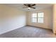 Bright bedroom features neutral carpet, ceiling fan, and a window with natural light at 4440 Cannon Rd, Loganville, GA 30052