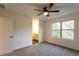 Carpeted bedroom with ceiling fan, window, and access to bathroom at 4440 Cannon Rd, Loganville, GA 30052