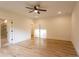Light-filled bedroom boasts wood floors, a ceiling fan and multiple doors to adjoining rooms at 4440 Cannon Rd, Loganville, GA 30052