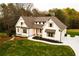 Charming two-story white home featuring stone accents, a well-manicured lawn, and an inviting driveway at 4440 Cannon Rd, Loganville, GA 30052