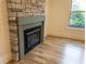 Close-up of a stone fireplace with hardwood floors at 4440 Cannon Rd, Loganville, GA 30052