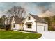 Charming two-story home with a manicured lawn, a well-lit walkway, and attached two-car garage at 4440 Cannon Rd, Loganville, GA 30052