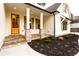 Inviting front porch with stone accents, a wooden door, and stylish design features at 4440 Cannon Rd, Loganville, GA 30052