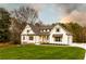 Charming two-story home with manicured front yard and inviting curb appeal and white exteriors at 4440 Cannon Rd, Loganville, GA 30052