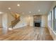 Bright living room with hardwood floors, fireplace, and staircase at 4440 Cannon Rd, Loganville, GA 30052