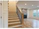 Staircase leading to living room with stone fireplace at 4440 Cannon Rd, Loganville, GA 30052